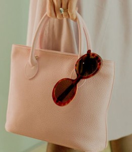 purse with sunglasses hanging over edge